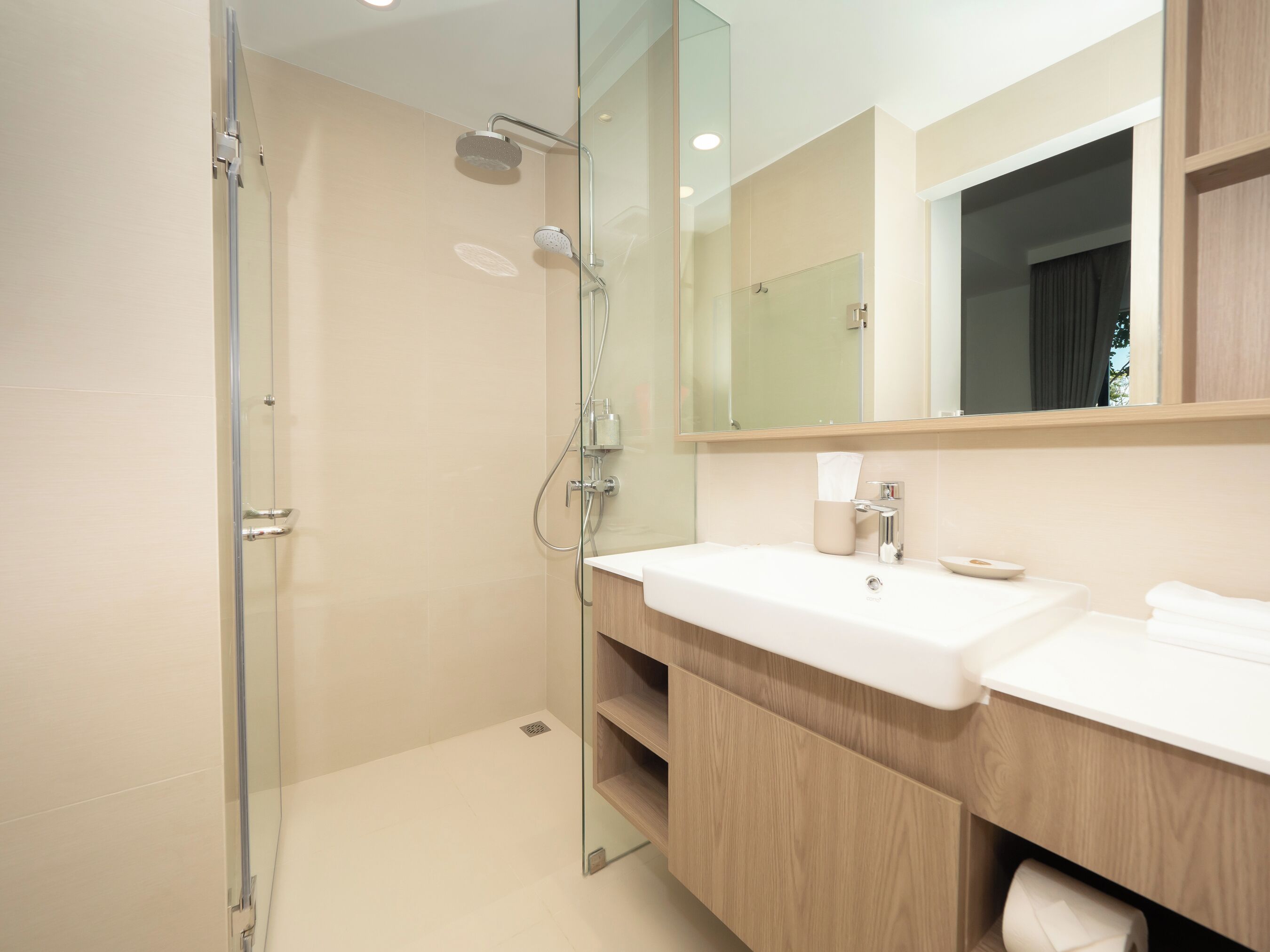 A modern bathroom with a glass shower enclosure, a double sink vanity, and a large mirror.