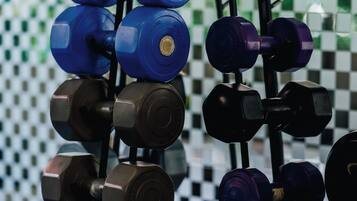 A rack of dumbbells in various colors.