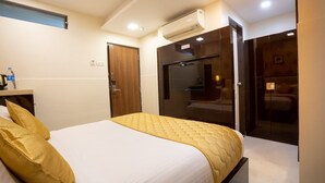 A hotel room with a bed, a wardrobe, a mirror, and an air conditioning unit. - Hotel Laaiba Residency (Mumbai)