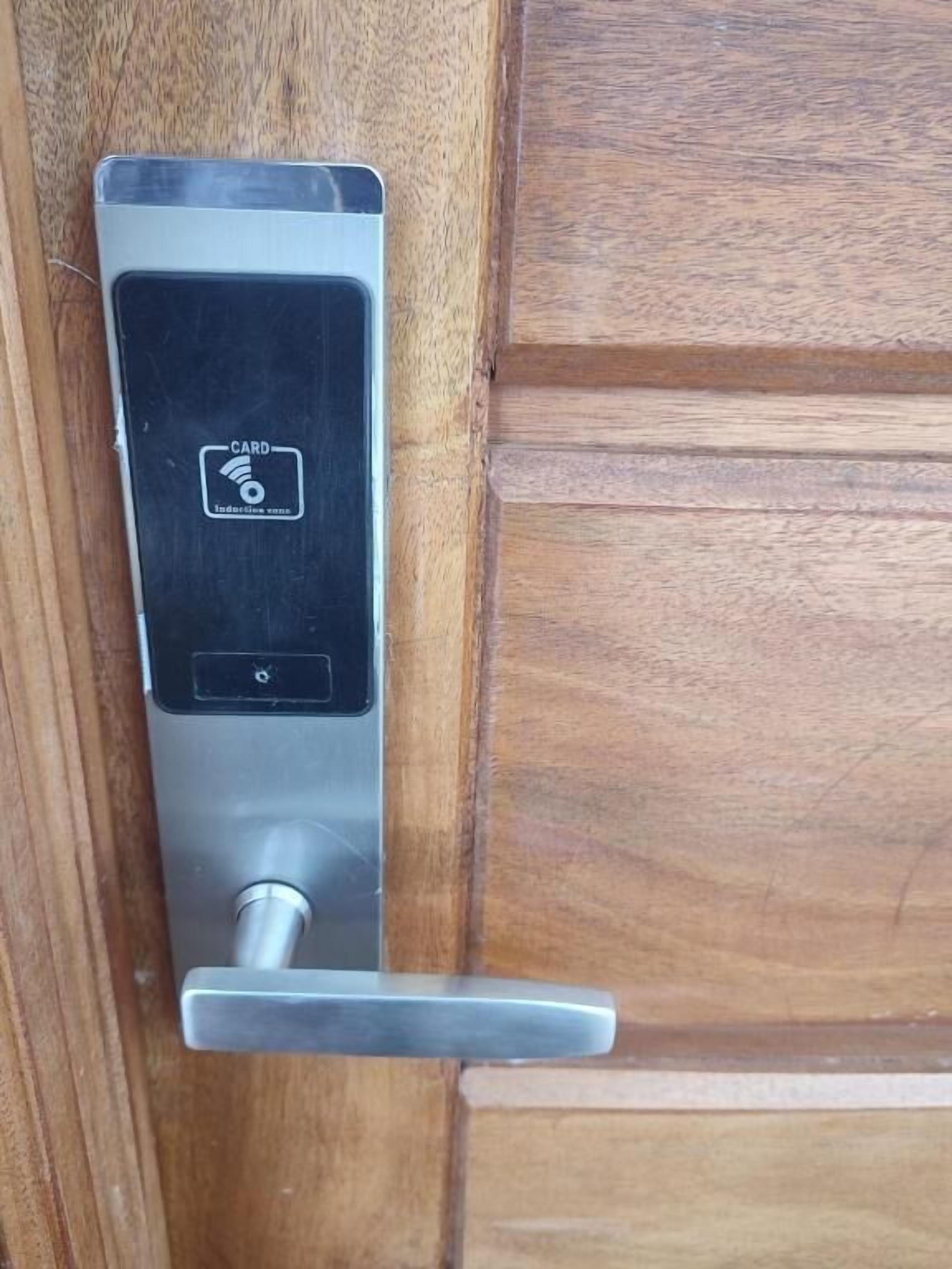 A door with a card reader and a keyhole.