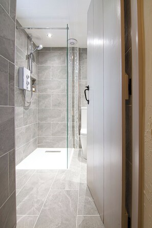 A modern shower area with a glass door, grey tiles, and a control panel. - GORGEOUS COUNTRY COTTAGE  -  5 STAR LUXURY AMIDST GLORIOUS MOUNTAIN SCENERY (Nr Sedbergh)