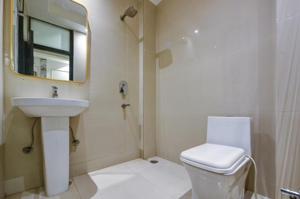 A bathroom with a sink, toilet, and shower.