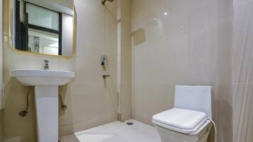 A bathroom with a sink, toilet, and shower.