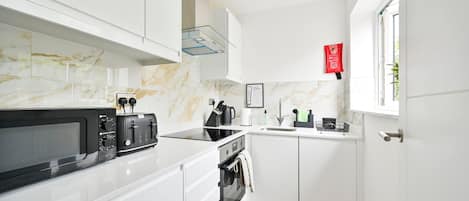 Fridge, microwave, toaster, dining tables