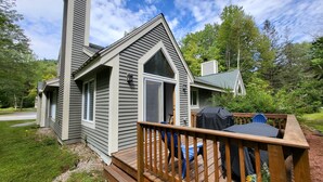 A house with a deck, a chimney, and a large window. - Multi-level, open concept, AC, wooded view, deck, swim club. F1602 by LRS (Lincoln)