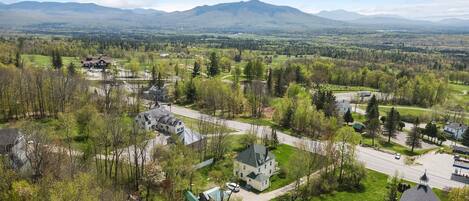 A residential area with houses, roads, and a mountainous backdrop.