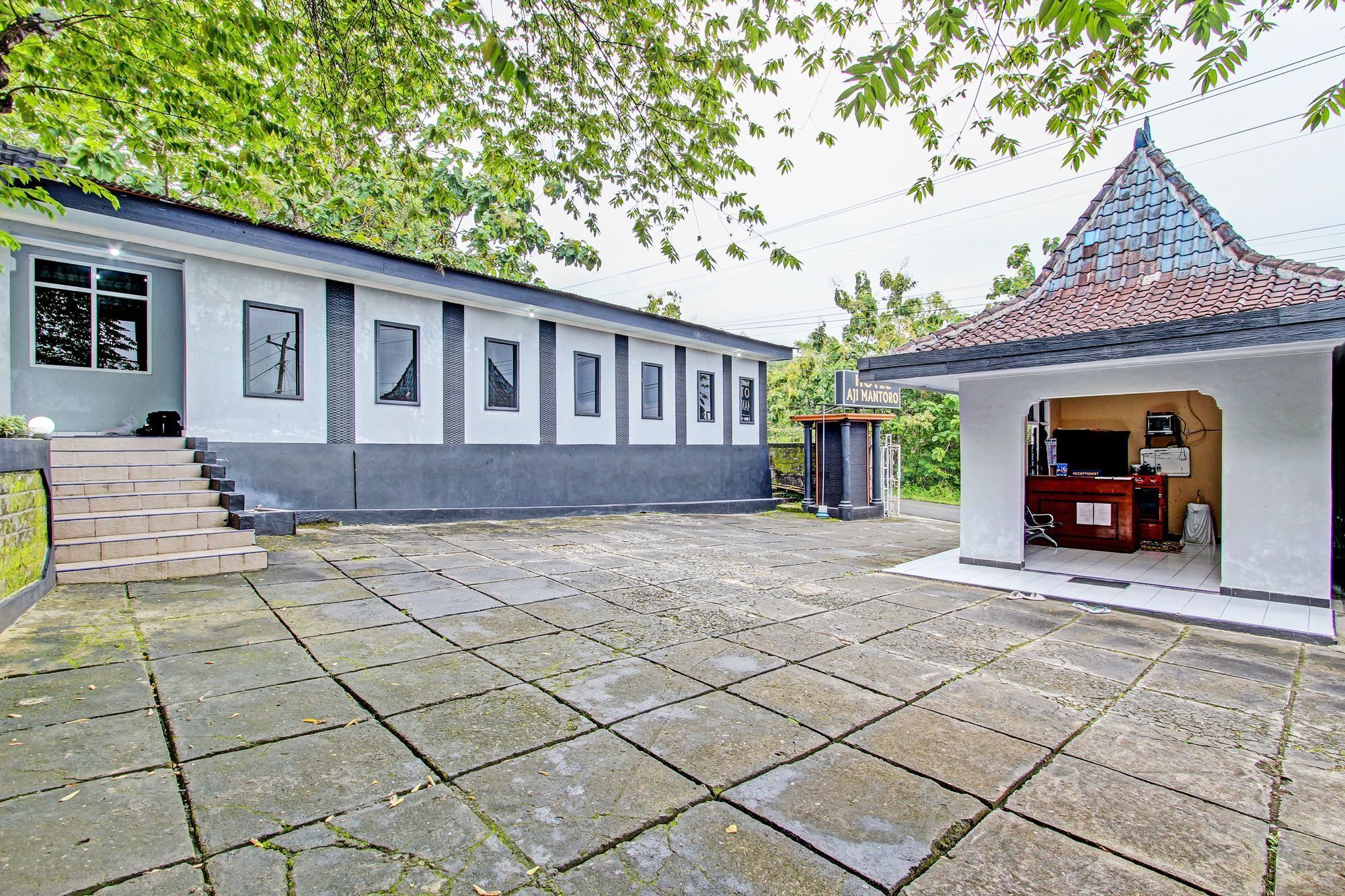 A building with a tiled roof and a small reception area.