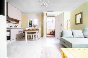 A modern apartment with a kitchen, dining area, and living room.