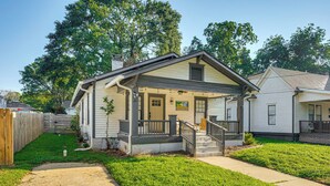 A single-story house with a front porch, a small front yard, and a wooden fence. - Walk to Beltline: Wfh-friendly Hub w/ Yard! (Atlanta)