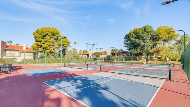A tennis court with multiple courts, surrounded by trees and buildings. - 3 Mi to Talking Stick: Condo w/ Community Perks! (Scottsdale)
