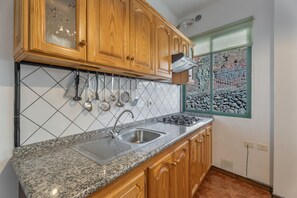 Fridge, microwave, stovetop, coffee/tea maker