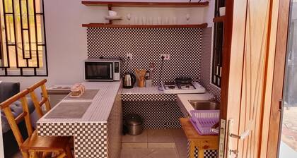 Charming bungalow with AC , flower garden in Dar es Salaam near beach resorts.