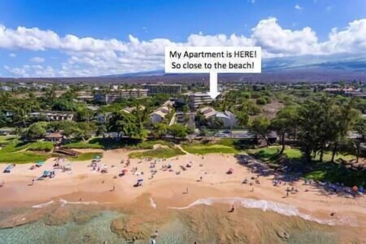 An aerial view of a residential area with a beach in the foreground.