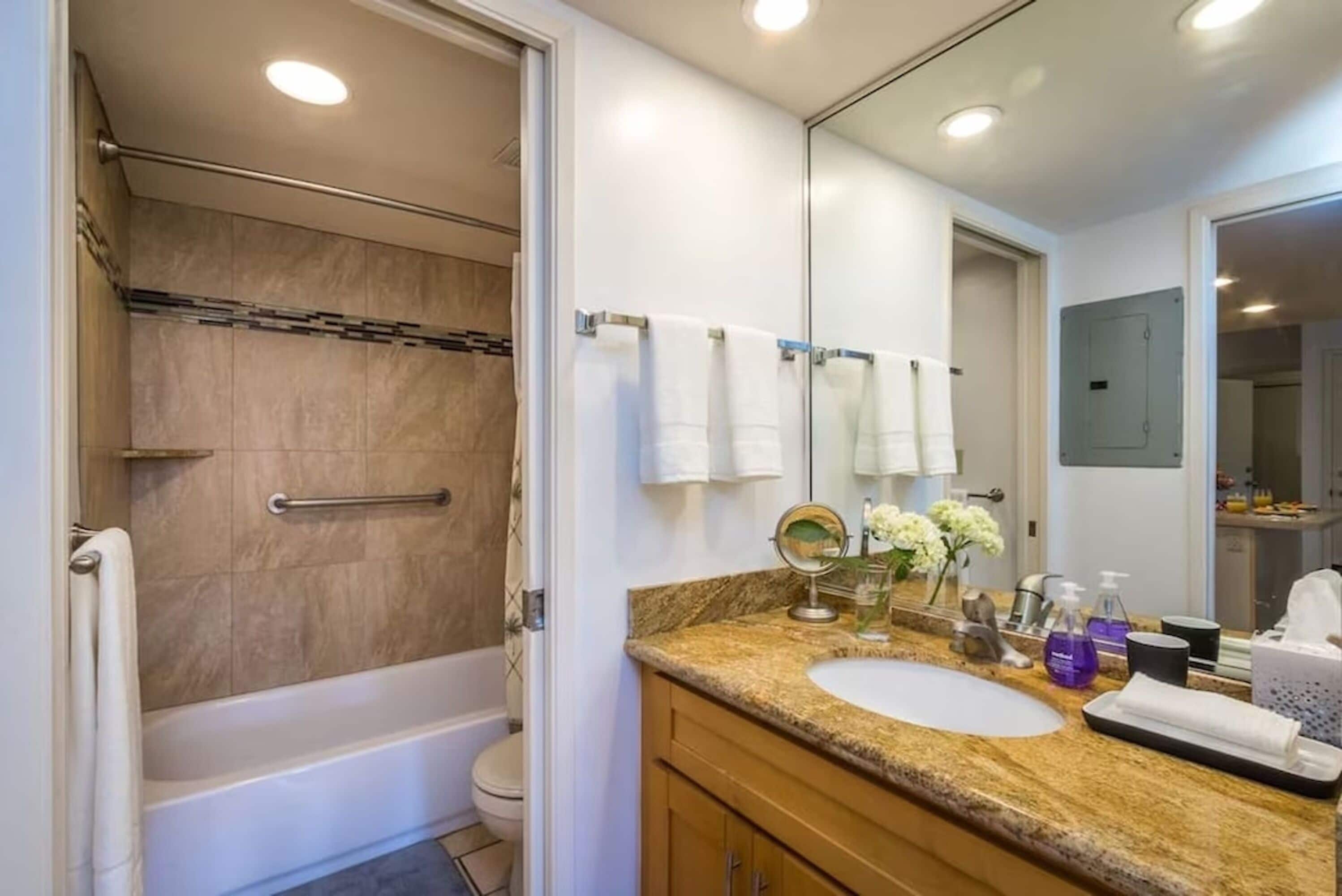 A bathroom with a bathtub, toilet, and sink.