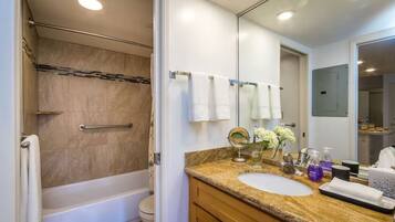A bathroom with a bathtub, toilet, and sink.