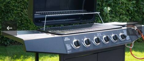 A grill with a control panel and a chimney.