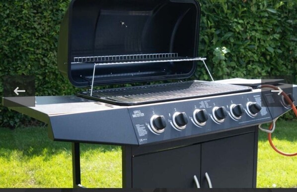 A grill with a control panel and a chimney.