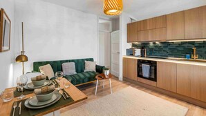 A modern kitchen with wooden cabinets, a built-in oven, and a countertop.