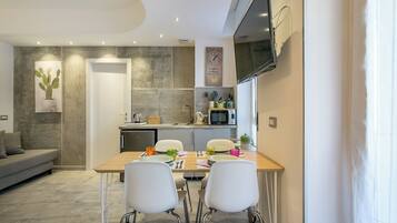 Studio, 1 Double Bed with Sofa bed, Balcony | Private kitchen | Electric kettle, dining tables
