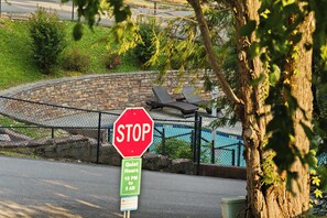 A stop sign with a green sign below it indicating quiet hours from 10 PM to 8 AM.