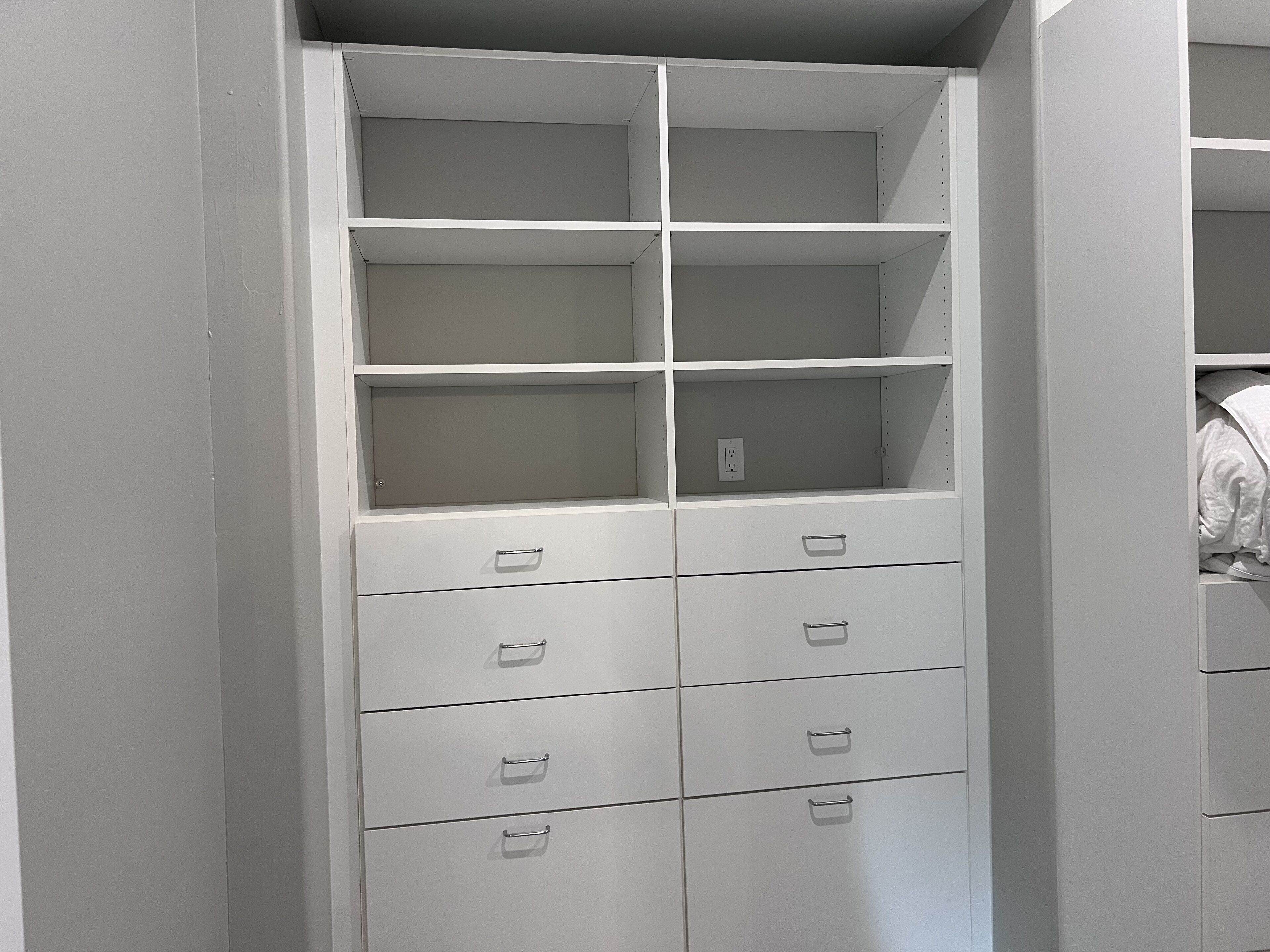 A white storage unit with multiple drawers and shelves, likely used for organizing personal items.