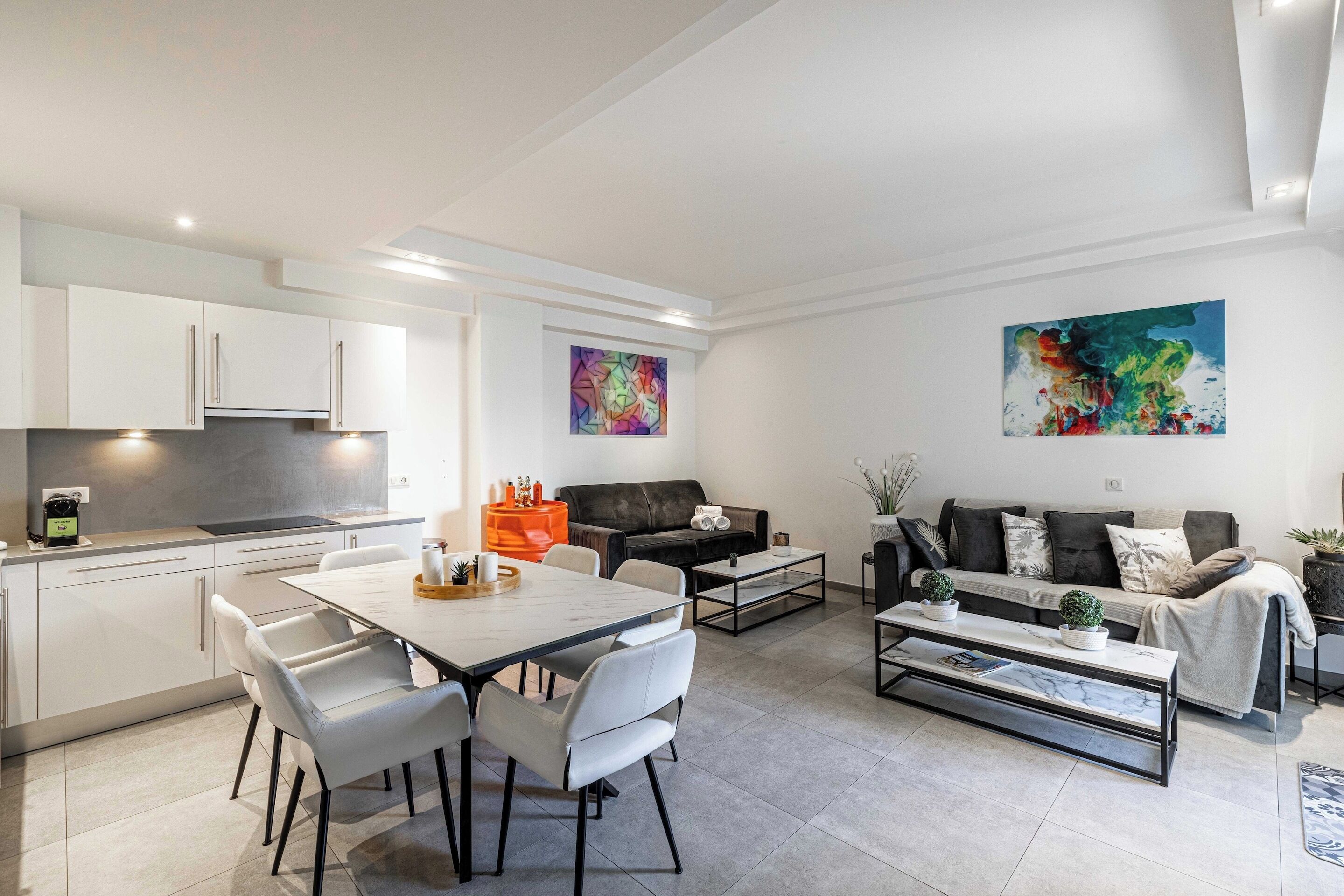 A modern apartment with a kitchen, dining area, and living room.