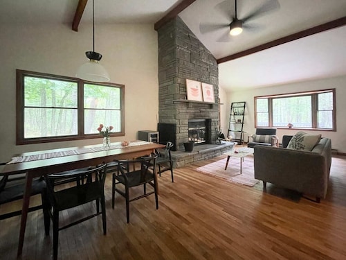 A peaceful, quaint cabin in the woods offers a country-side escape for couples, small families, and friends.