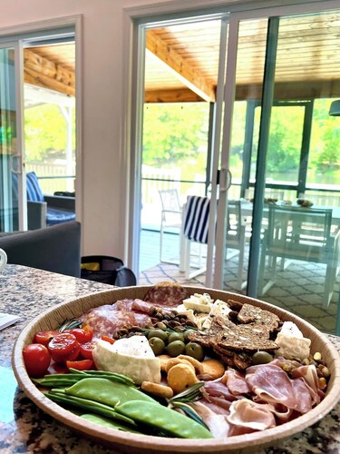 Chic lakefront retreat with year-round charm. Enjoy Lake Barnabee views, a fully stocked kitchen, and cozy vibes in a nostalgic lake community. Kayak in summer, skate in winter, and take advantage of fun in-home concierge services.