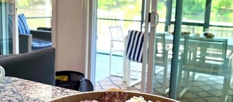 Chic lakefront retreat with year-round charm. Enjoy Lake Barnabee views, a fully stocked kitchen, and cozy vibes in a nostalgic lake community. Kayak in summer, skate in winter, and take advantage of fun in-home concierge services.