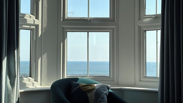 A room with a view of the sea through a large window. - Belle's View (Scarborough)