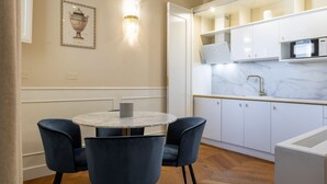 A modern kitchen with white cabinets, a marble countertop, and a built-in microwave. - Calzaiuoli Gold Private House with Terrace (Firenze)