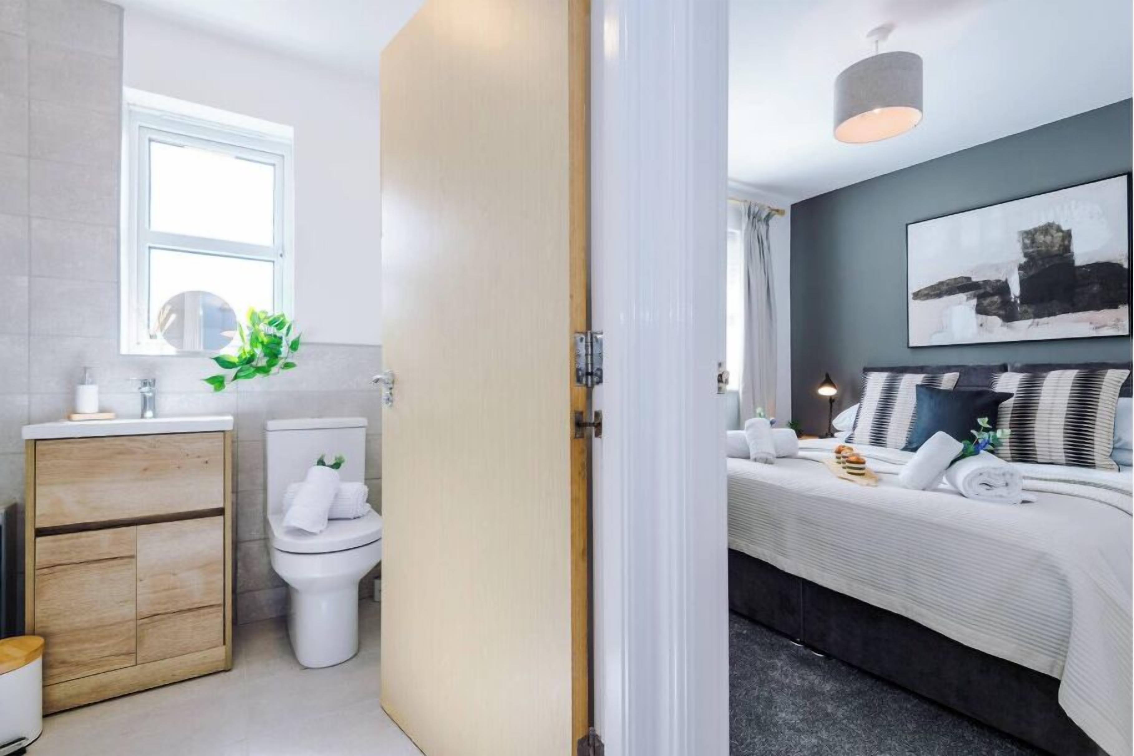 A modern bathroom with a toilet, sink, and cabinet.