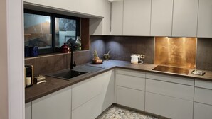 A modern kitchen with white cabinets, a stainless steel sink, and a window with a view. - BEAUTIFUL HOUSE IN PROVENCE (Avignon)