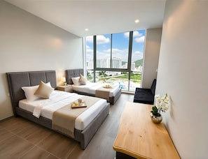 A hotel room with two beds, a small table, a sofa, and a large window offering a city view. - Apartamentos Salguero Sunset - by SOHO (Santa Marta)