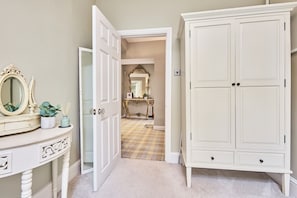 Interior - Luxury 3‑bed apartment on Haworth’s famous Main Street. Light‑filled lounge with large, deep sofas, wood burner and 75" smart TV with Netflix, plus high‑end kitchen. Hotel‑quality beds and linen, parking, patio, bike store and dog friendly. (Haworth)