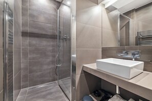 Shower, hair dryer, towels, toilet paper