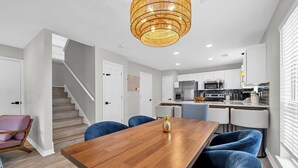 A modern kitchen with white cabinets, a stainless steel refrigerator, and a microwave. - ☀️Beautiful Views-Bikes-Pet Friendly-30A-Milo's Beach Bungalow☀️ (Santa Rosa Beach)