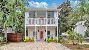A two-story house with a pink door and a number 223 on the front. - ☀️Beautiful Views-Bikes-Pet Friendly-30A-Milo's Beach Bungalow☀️ (Santa Rosa Beach)