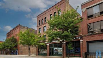 A street view with a building labeled 'CAM O'KORN PROPERTIES' and a number '37' on the side.