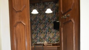 A wooden door leading to a dining area with a 'WELCOME' mat, a patterned wallpaper, and a chandelier. - In the heart of Caprarola cozy apartment within walking distance of all services (Caprarola)