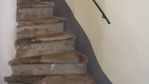 A staircase with a curved wall and a metal handrail. - In the heart of Caprarola cozy apartment within walking distance of all services (Caprarola)