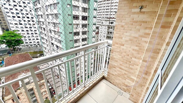 A balcony with a view of high-rise buildings. - 2 Min da Praia - 2Q - Vaga de Garagem (Santos)