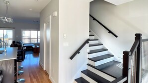 A spacious living area with a staircase leading to an upper floor. - Your Halifax Getaway – Relax & Explore (Halifax)