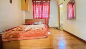 A bedroom with a wooden bed, red curtains, and a tiled floor. - Hotel O Bougenville Resort (Cipanas)