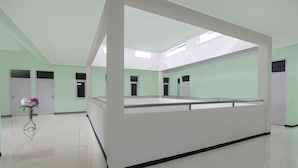 A spacious room with a central display area, white walls, and a tiled floor.