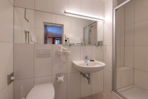 Shower, hair dryer, towels, toilet paper