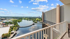 A high-rise hotel with a view of a lake and surrounding greenery. - Bright & Spacious Condo 1BD! Steps from the Beach! (Panama City Beach)