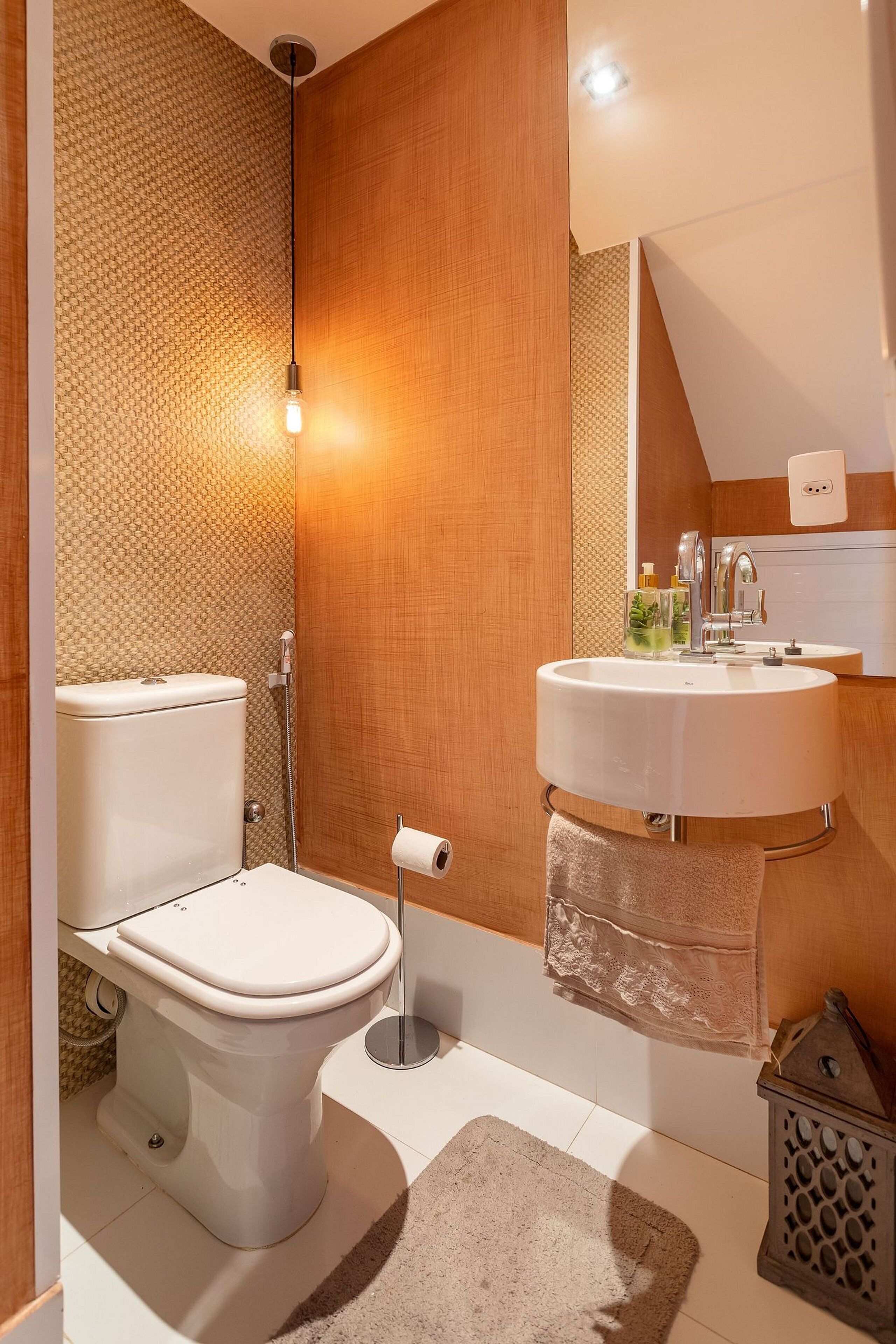 A modern bathroom with a toilet, sink, and shower.