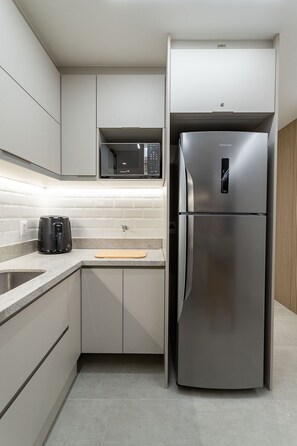 Fridge, microwave, coffee/tea maker, cookware/dishes/utensils