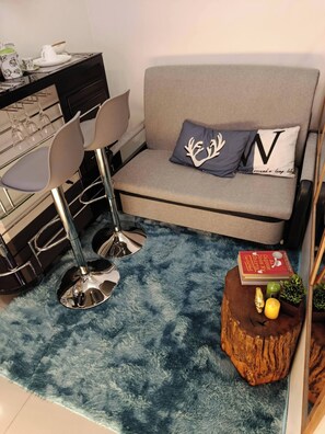Condo, 1 Bedroom, Accessible | Living area | Books - Modern Condo Retreat in Quezon City With Resort-style Pool (Quezon City)
